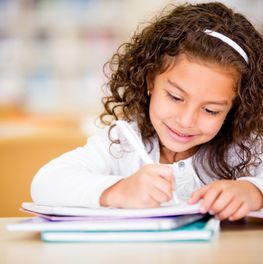 Girl studying at school looking very happy